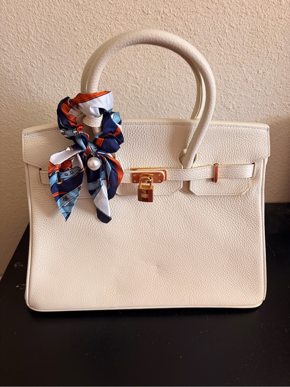 Elegant White Structured Top-Handle Handbag with Gold Hardware